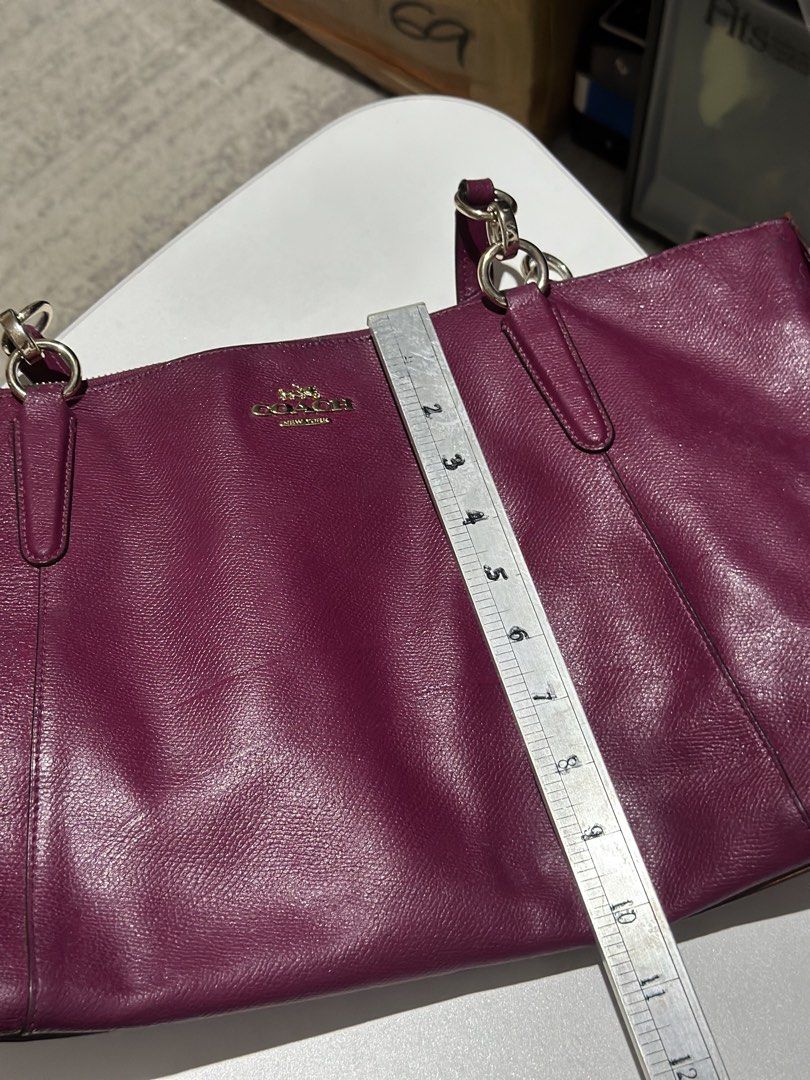 Coach Tote Bag Berry Purple Leather (Category: Luxury Bags & Wallets) located in Daet. Submitted by thrifthings2018 (Listing ID 1470450359, Image 3). Description: - Brand: Coach - Material: Berry purple pebble leather with gold hardware - Closure: Zip top - Straps: Double shoulder straps - Dimensions: Approx. 16" wide x 11" tall - Condition/Shape: Clean interior, structured shape - Features: Great everyday size for work or school; easily fits lap