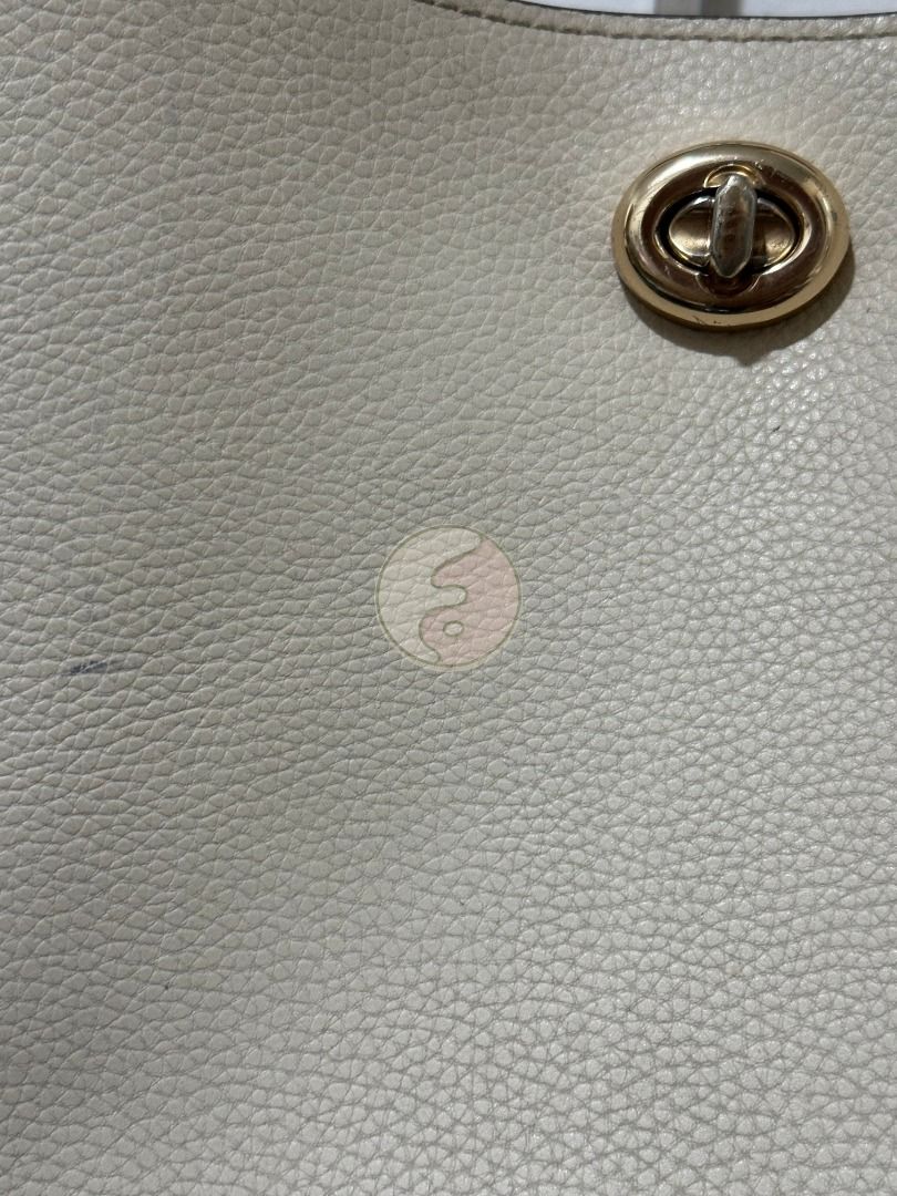 Coach White Leather Charlie Bucket (Category: Luxury Bags & Wallets) located in Mandaluyong City. Submitted by adoresellie (Listing ID 1470439125, Image 3). Description: 2019 Coach White Leather Charlie Bucket 55200 Made in Vietnam Preloved bag with FLAWS (check photos): - Small blue stains in body - Stains inside body - Replaced slings, but still Coach - Heavy - Not for resellers - Bawal sa maselan RFS: Decluttering Disclaimer: Not affiliated wi