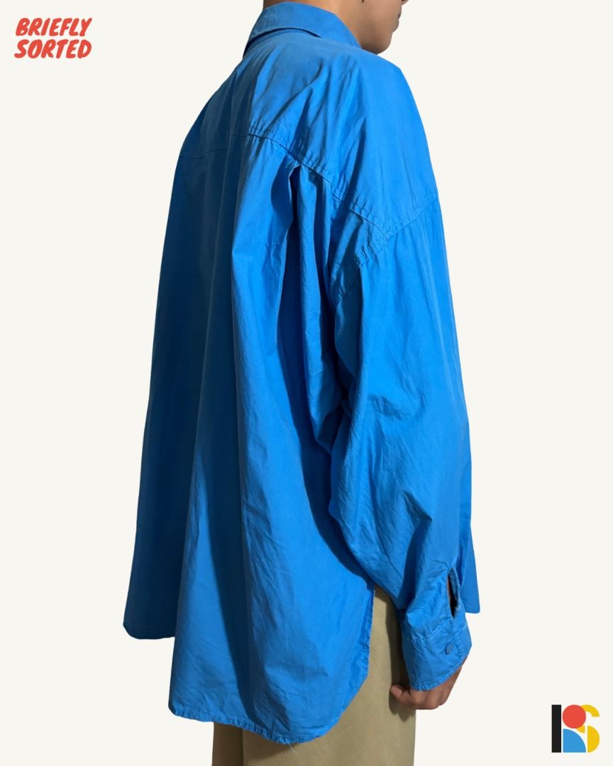 Cobalt Blue Oversized Button Down Shirt / Statement Draped Collar Long Sleeve Polo (Category: Shirts) located in Alabel. Submitted by brieflyavailable (Listing ID 1470420107, Image 3). Description: Color: Vibrant Cerulean / Cobalt Blue Fabric & Feel: Crisp, lightweight cotton-poplin weave; breathable, smooth against the skin, and holds its architectural drape Size & Fit: Roomy, genderless/unisex oversized fit with deep drop shoulders and a billow