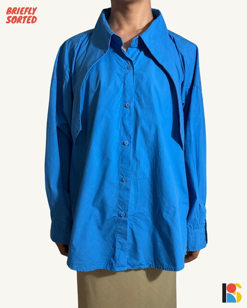Cobalt Blue Oversized Button Down Shirt / Statement Draped Collar Long Sleeve Polo (Category: Shirts) located in Alabel. Submitted by brieflyavailable (Listing ID 1470420107, Image 1). Description: Color: Vibrant Cerulean / Cobalt Blue Fabric & Feel: Crisp, lightweight cotton-poplin weave; breathable, smooth against the skin, and holds its architectural drape Size & Fit: Roomy, genderless/unisex oversized fit with deep drop shoulders and a billow