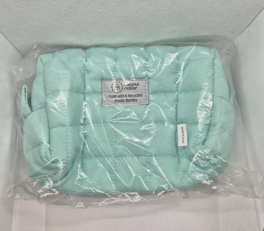 Coconut Matter Quilted Mint Green Makeup Pouch (Category: Purses & Pouches) located in Manila. Submitted by prelovedbyc.hannah (Listing ID 1470357994, Image 1). Description: - Brand: Coconut Matter - Color: Mint green - Material: 100% recycled plastic bottles (6 bottles used) - Design: Soft quilted fabric with top zipper closure - Use: Ideal for makeup, toiletries, or daily essentials - Condition: Brand new, still sealed in original plastic packa