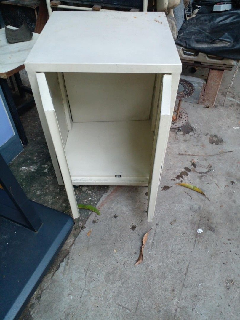 Compact Metal Storage Cabinet with Double Doors (Category: Shelves, Cabinets & Racks) located in Manila. Submitted by wisegem-231b (Listing ID 1470397347, Image 1). Description: - Color: Cream with black handles - Material: Sturdy metal frame - Design: Two hinged doors with open interior shelf space - Versatile Use: Ideal for workshop, office, or garage storage - Space-Saving: Compact footprint fits easily into tight corners.