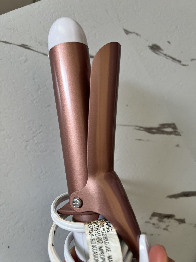 Curling Iron (Category: Hair) located in Taytay. Submitted by cris-ann (Listing ID 1470358198, Image 3). Description: - Brand: Conair Curling Iron - Color: Aesthetic White & Rose Gold - Features: Metallic spring clamp barrel, turbo button, on/off switch, and indicator light - Plug Type: Standard PH two-prong plug with white cord (built-in cord wrap for easy storage) - Condition: Good working conditions - MOP: Cash - SF: Buyer shoulders shipping f