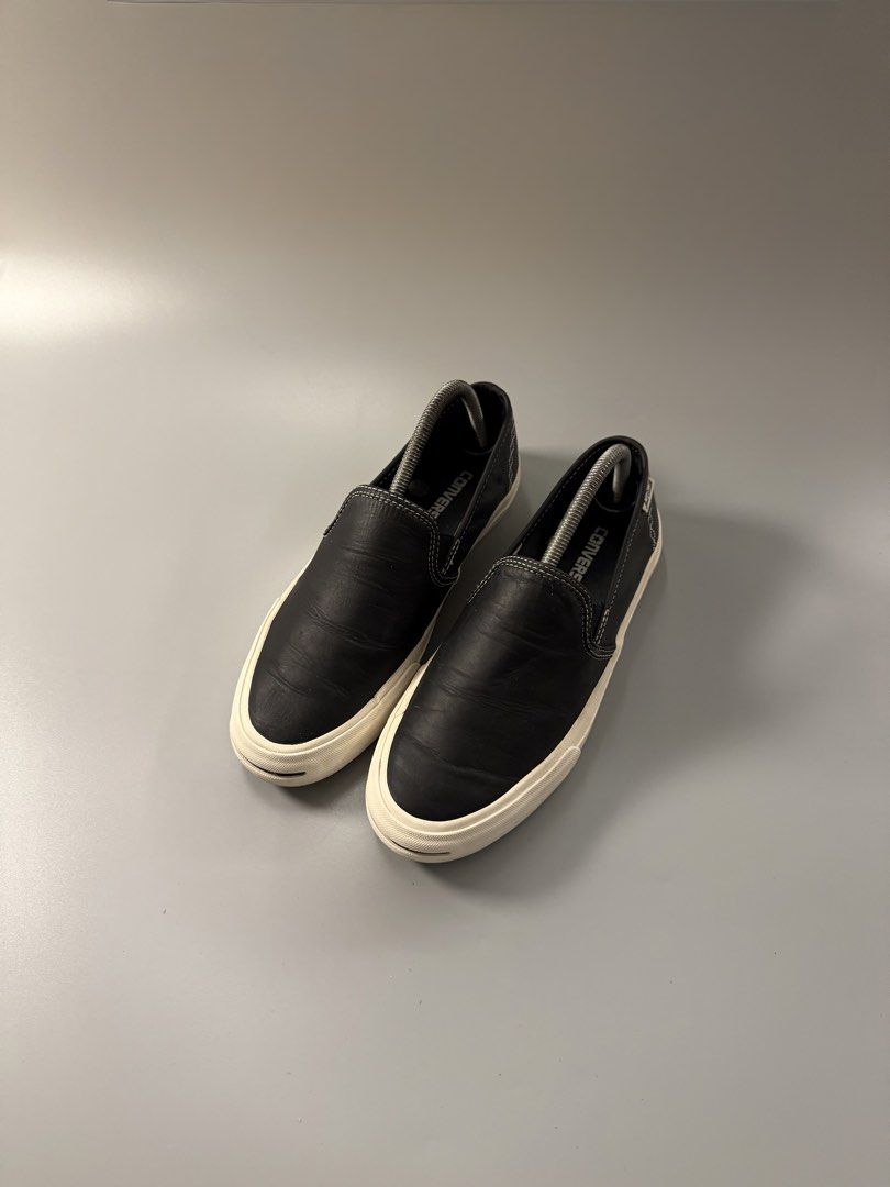 Converse Jack Purcell Black Leather Slip-On (Category: Sneakers) located in Quezon City. Submitted by markieexp (Listing ID 1470460520, Image 2). Description: - Brand: Converse Jack Purcell - Style: Black leather slip-on sneakers with elastic side goars - Details: White contrast stitching, brown suede heel tab with white cross-stitching - Sole: Classic toe smile on the rubber midsole, grey outsoles with minimal wear - Condition: Well-maintained, 