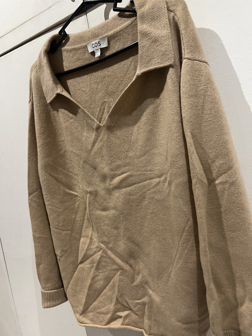 COS Collared V-Neck Knit Sweater Camel Size M (Category: Coats, Jackets and Outerwear) located in Quezon City. Submitted by Zandee (Listing ID 1470487356, Image 2). Description: - Brand/Model: COS knit sweater - Color: Camel brown - Size: EUR M - Design: V-neckline with a pointed collar - Fit: Relaxed fit with long sleeves and ribbed cuffs - Material: Soft knit, ideal for layering during cooler weather - Condition: Excellent.