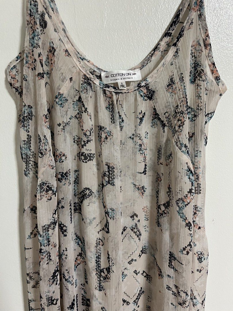 Cotton On Printed Spaghetti Strap Maxi Dress (Category: Dresses) located in Cabuyao City. Submitted by rdtrmt (Listing ID 1470450562, Image 2). Description: - Brand: Cotton On - Size: Small - Style: Relaxed fit maxi dress with a flowy silhouette and pullover style - Straps: Adjustable spaghetti straps - Fabric: Lightweight, sheer material - Design: All-over abstract geometric print in black, blue, and pink on a neutral off-white background - Cond