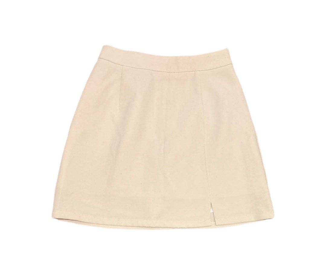 Cream A-line Mini Skirt with Front Slit (Category: Skirts) located in Manila. Submitted by areiei (Listing ID 1470367680, Image 1). Description: - Color: Cream - Brand: DAZY Shein - Style: High-waisted mini skirt with smooth structured fabric - Details: Clean waistband, front stitching lines, and a small vertical hem slit on the right - Versatility: Perfect for pairing with basic tees or chic blouses SF Shouldered by Buyer.