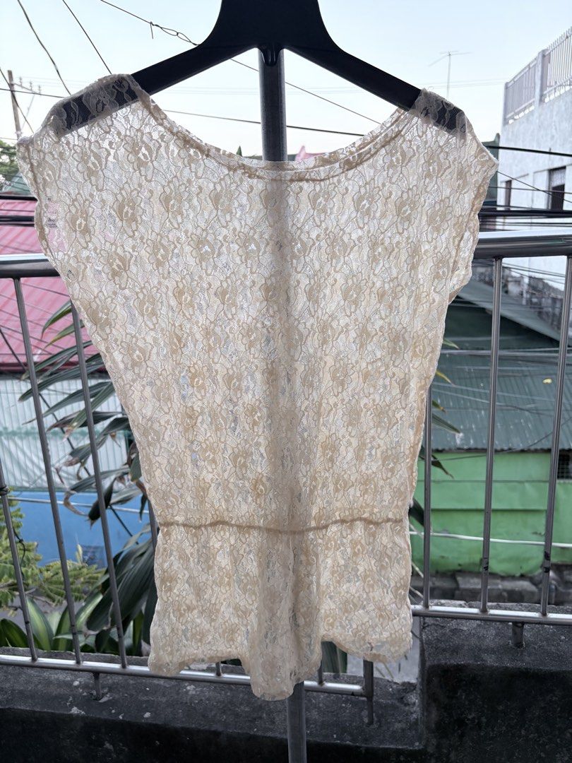 Cream Lace Short Sleeve Blouse (Category: Blouses) located in Cavite. Submitted by earthread (Listing ID 1470453851, Image 2). Description: - Style: Cream lace top with short sleeves and cinched waist - Design: All-over floral lace pattern with a lightweight, slightly sheer fabric - Versatility: Pairs easily with skirts or high-waisted pants for casual days - Condition: Brand new / Excellent (ready to ship!).