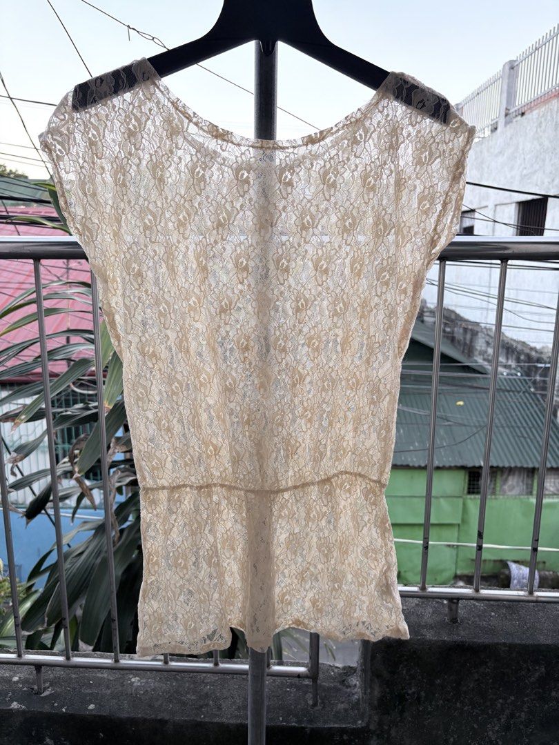 Cream Lace Short Sleeve Blouse (Category: Blouses) located in Cavite. Submitted by earthread (Listing ID 1470453851, Image 1). Description: - Style: Cream lace top with short sleeves and cinched waist - Design: All-over floral lace pattern with a lightweight, slightly sheer fabric - Versatility: Pairs easily with skirts or high-waisted pants for casual days - Condition: Brand new / Excellent (ready to ship!).