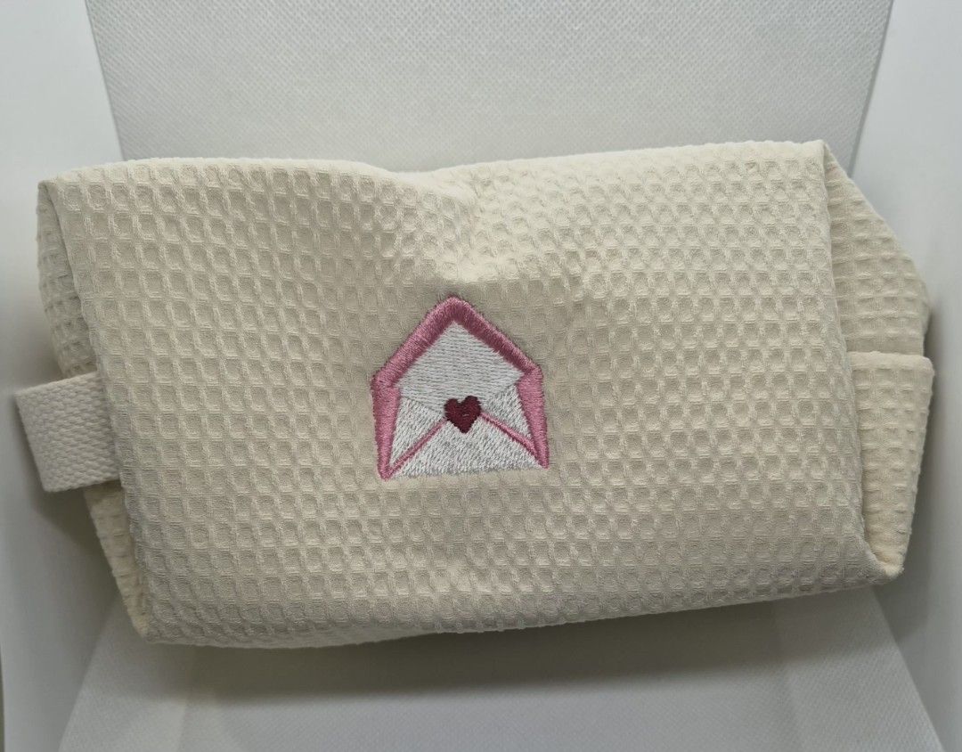 Cream Waffle Cosmetic Pouch with Envelope Embroidery (Category: Purses & Pouches) located in Manila. Submitted by prelovedbyc.hannah (Listing ID 1470358678, Image 1). Description: - Free pouch upon purchase of any Dior cosmetic set - Color & Material: Cream-coloured waffle fabric - Design: Cute embroidered love letter envelope with a tiny red heart - Interior: Fully lined in white fabric with built-in slip pockets - Hardware: Sturdy white zipper 