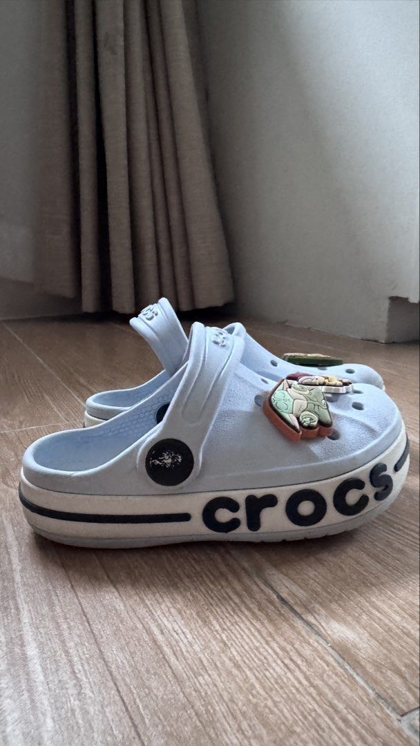 Crocs Size C8 Light Blue Bayaband Clog with Charms (Category: Babies & Kids Fashion) located in Cainta. Submitted by littlemissvietnam (Listing ID 1470442427, Image 1). Description: - Color: Light blue with black side branding - Style: Platform sole, slip-on with pivoting heel strap - Condition: Clean with minimal wear - Inclusions: 3 character charms (Groot, Baby Yoda, and Aang) - Comfort: Iconic Crocs comfort footbed.