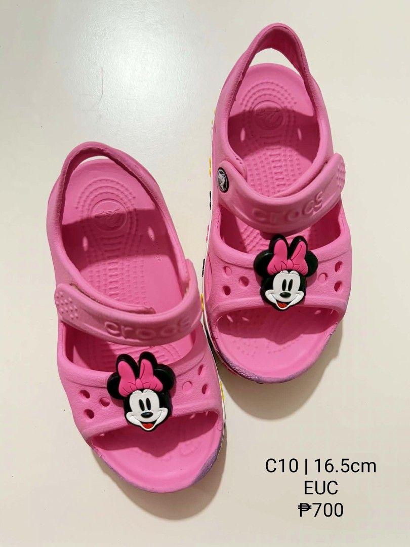 Crocs Minnie Mouse Pink Sandals C10 (Category: Babies & Kids Fashion) located in San Fabian. Submitted by hbrst1998 (Listing ID 1470359029, Image 1). Description: - Authentic bright pink Crocs with adorable Minnie Mouse Jibbitz charms - Secure fit featuring an adjustable heel strap and front Velcro closure - Size: C10 (16.5 cm) - Made of comfortable, lightweight rubber material - Super easy to clean and maintain - Ideal fun footwear for young Dis