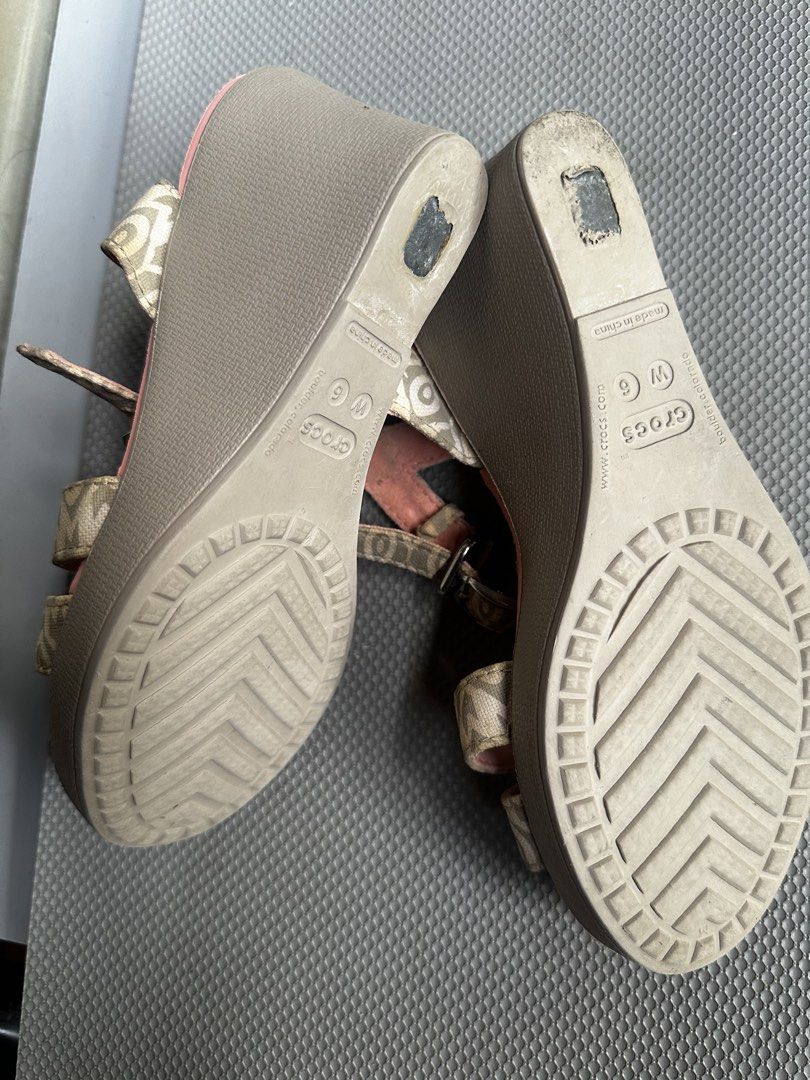 Crocs Wedge Sandals Patterned Strap Pink Women Size 6 (Category: Wedges) located in Digos. Submitted by venusacaro13427 (Listing ID 1470432576, Image 3). Description: - Brand/Style: Crocs wedge sandals - Size: Women's US 6 - Design: Pink textured footbed with patterned beige fabric upper and ankle straps - Closure: Adjustable side buckle - Heel: Brown wedge with great traction - Condition: Minor wear on bottom soles from previous use - Features: 