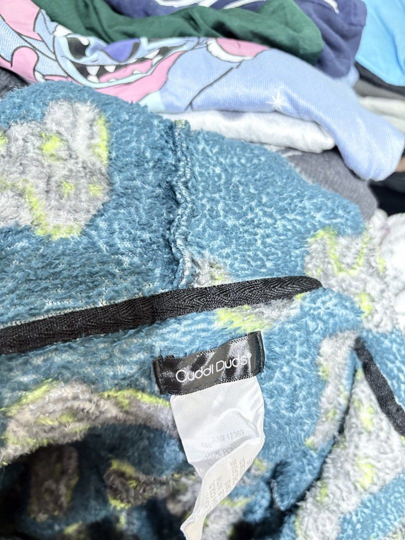 Cuddl Duds Plush Video Game Pattern Bathrobe Hooded (Category: Coats, Jackets and Outerwear) located in General Trias. Submitted by crissy9053136 (Listing ID 1470487101, Image 3). Description: - Brand: Cuddl Duds - Color: Dark teal blue with grey and lime green video game controller print - Material: Super soft and warm plush fleece - Features: Attached hood, long sleeves, front pockets, and black tie belt - Condition: Excellent lounge piece, tag