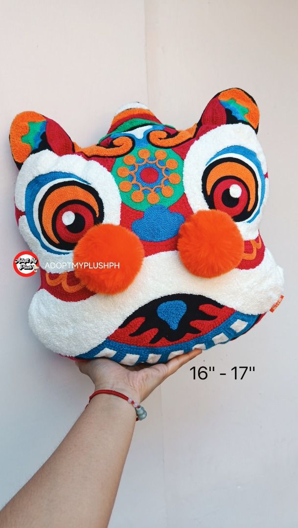 {Cushion} 16" CNY Chinese Lion Decor Throw Pillow (Category: Cushions & Throws) located in Taguig. Submitted by adopt.my.plush.ph (Listing ID 1470449330, Image 3). Description: A vibrant Chinese Lion Dance plush throw pillow, popular as a festive home decoration for Lunar New Year and special celebrations. Product Details Design Features: Intricate traditional embroidery, plush textured fabric, a wide stylized smile, and distinctive three-dimensi