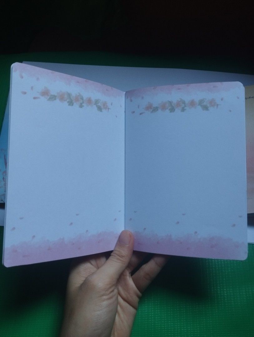 Cute Cherry Blossom Notebook Japanese Aesthetic Diary (Category: Stationery & School Supplies) located in San Mateo. Submitted by diana_01.tree (Listing ID 1470350755, Image 3). Description: - Cover: Soft pink with a charming cherry blossom tree illustration, pocket size - Back: Features Japanese text and a cute small heart - Pages: Pretty floral borders at the top, watercolor wash, and with designs inside pages - Design: Slim and lightweight, ea