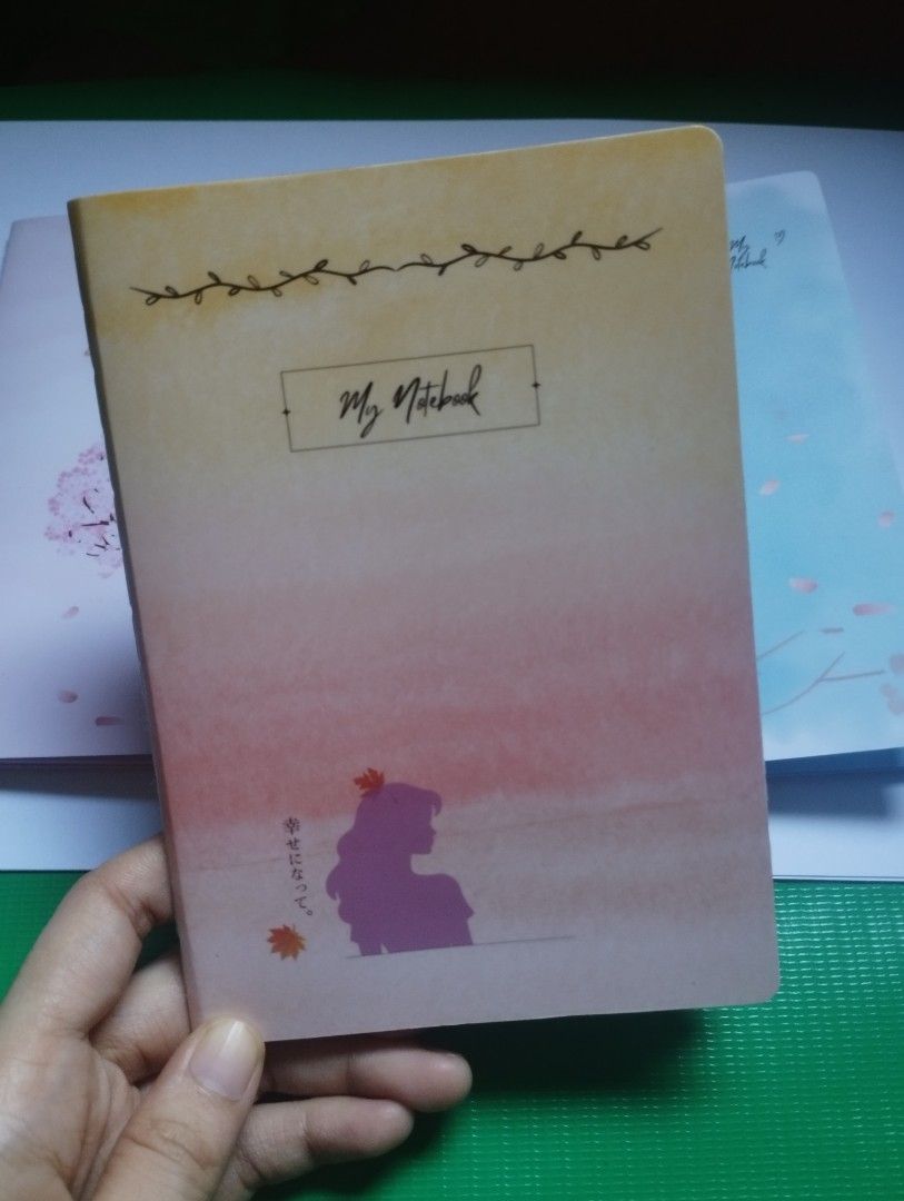 Cute Gradient Autumn Aesthetic Notebook Diary Journal (Category: Stationery & School Supplies) located in San Mateo. Submitted by diana_01.tree (Listing ID 1470351396, Image 1). Description: - Design: Gradient orange & yellow cover with aesthetic autumn girl art and Japanese text details - Inside Pages: Features lovely watercolor headers with cute maple leaf graphics - Condition: Brand new, clean pages, ready for writing - Best For: Journaling, d