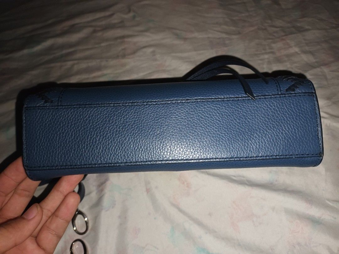 Dark blue structured crossbody handbag with patterned lining and strap (Category: Cross-body Bags) located in Manila. Submitted by lemlem_10 (Listing ID 1470370226, Image 3). Description: Dark blue faux leather crossbody bag. Textured pebble finish with decorative contrast stitching on the front flap and silver-tone hardware lock. Includes a matching adjustable shoulder strap with metal clips. Interior features patterned fabric lining with multip