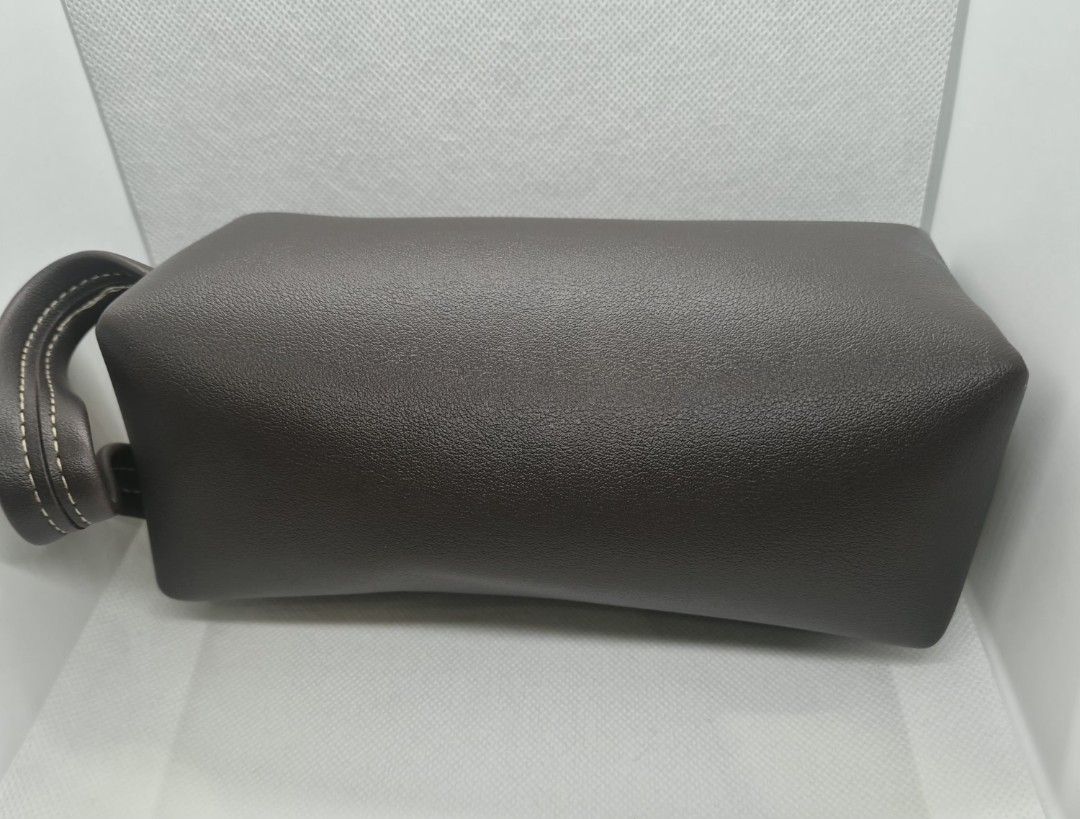 Dark Brown Leather Toiletry Pouch with Wrist Strap (Category: Purses & Pouches) located in Manila. Submitted by prelovedbyc.hannah (Listing ID 1470359051, Image 3). Description: - can be Free upon purchase of Dior cosmetic set - Color/Material: Dark brown faux leather with a stylish textured finish - Accents: Elegant contrast stitching and gold-tone top zipper - Portability: Includes a matching detachable wrist strap - Interior: Spacious with dar