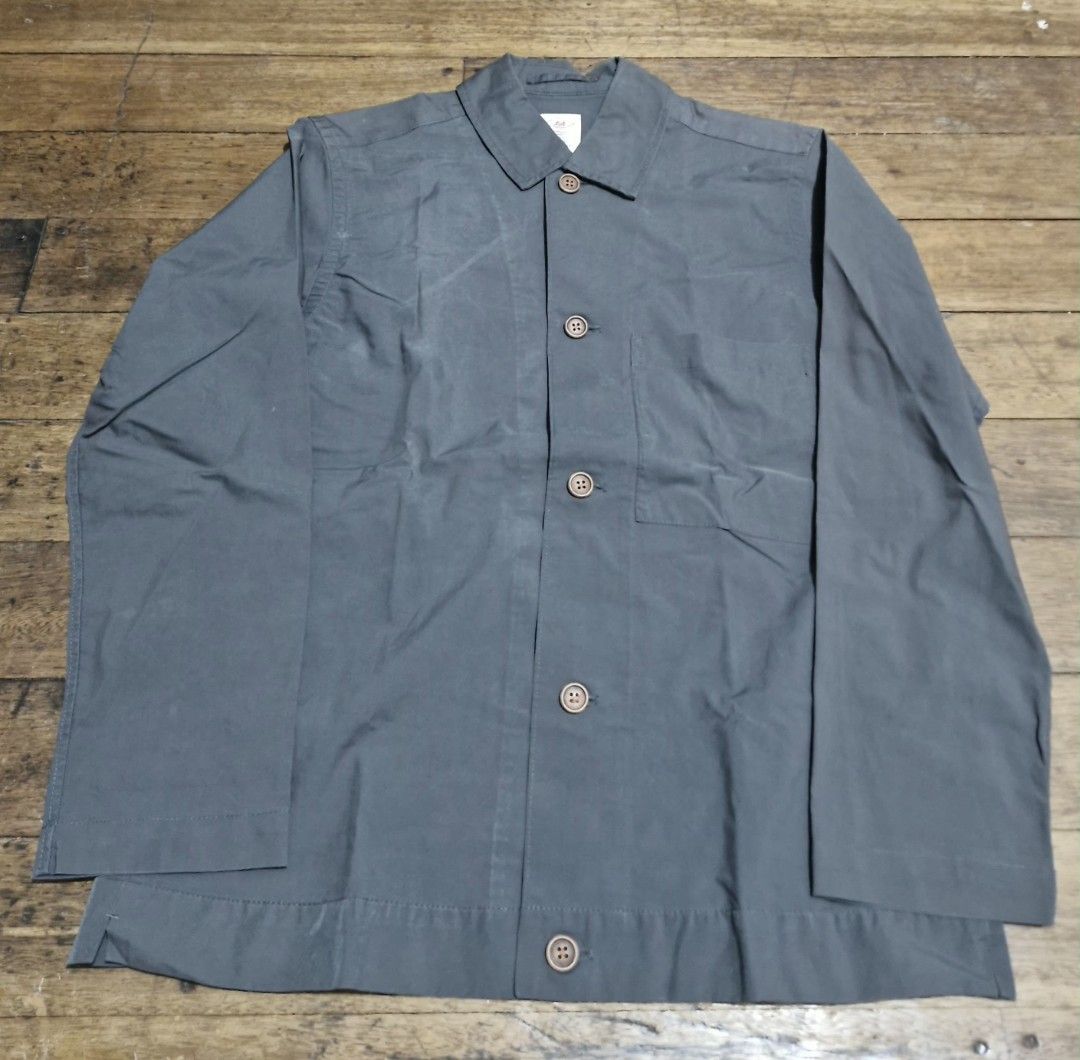 Dark Grey Button-Up Casual Long Sleeve Jacket (Category: Coats, Jackets and Outerwear) located in Manila. Submitted by blackstarharpoon (Listing ID 1470525623, Image 1). Description: - Color: Dark grey - Style: Long sleeve button-up jacket with classic collar - Details: Single chest pocket on the right side, brown front buttons, straight hem with small side slits - Fabric: Lightweight and breathable, ideal for layering over tees or shirts - Condi