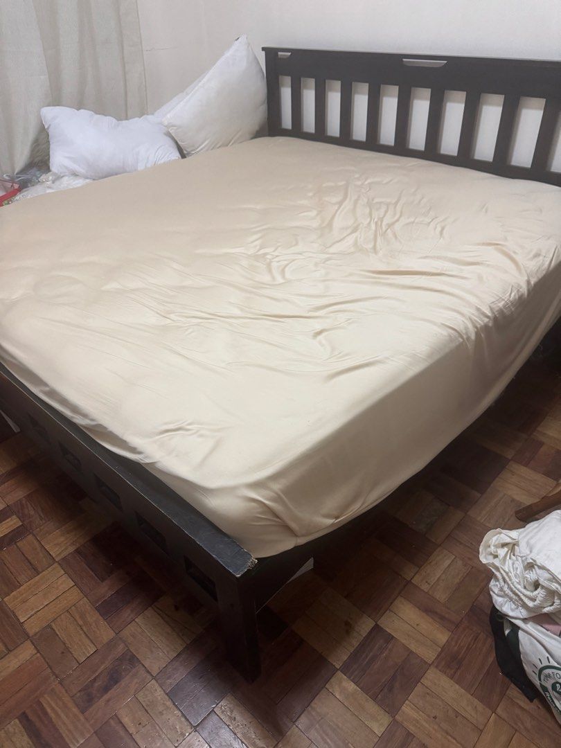 Dark Wood Bed Frame with Mattress (Category: Bed Frames & Mattresses) located in Paranaque City. Submitted by jiggybautista (Listing ID 1470392941, Image 2). Description: - Dark wooden bed frame with easy-lift slat base for spacious under-bed storage - Includes a comfortable quilted mattress with a fitted beige sheet - Sturdy structure with normal wear on the corners - Fits standard mattress sizes - Perfect upgrade for your bedroom - Pickup only 