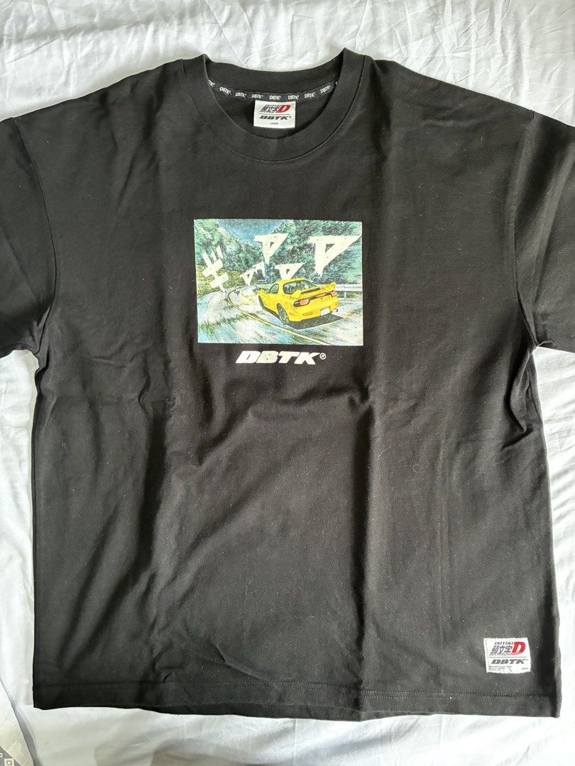 DBTK x Initial D Keisuke T-Shirt Size L (Category: Tshirts & Polo Shirts ) located in Manila. Submitted by nikkoour (Listing ID 1470407859, Image 2). Description: - Authentic DBTK x Initial D collaboration tee - Color: Black - Size: Large (tag at collar with branded neck tape) - Design: Small front manga print with yellow car and DBTK logo; large multi-panel back graphic featuring Keisuke's FD RX-7 and character portrait - Details: Woven collab p