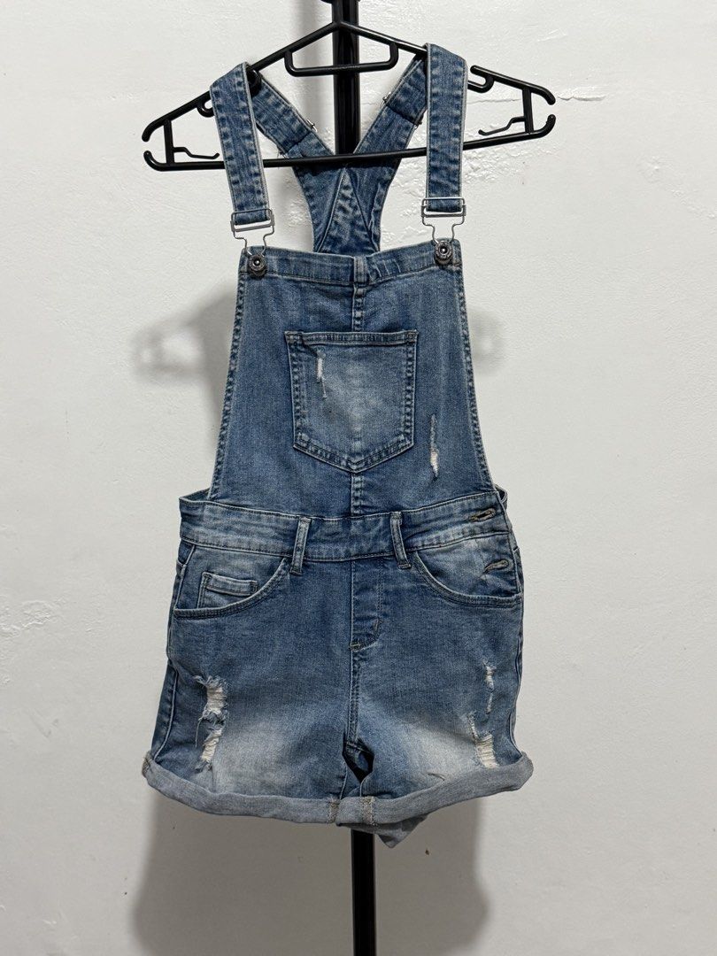 Denim Overalls Shorts Distressed Wash (Category: Jumpsuits) located in Mandaluyong City. Submitted by jdflores17 (Listing ID 1470456628, Image 1). Description: - Style: Medium wash denim overall shorts - Details: Distressed accents on bib pocket and hems, with stylish rolled cuffs - Hardware: Silver-tone buttons and adjustable metal strap buckles - Pockets: Multiple functional pockets on the front and sides - Design: Classic racerback straps for 