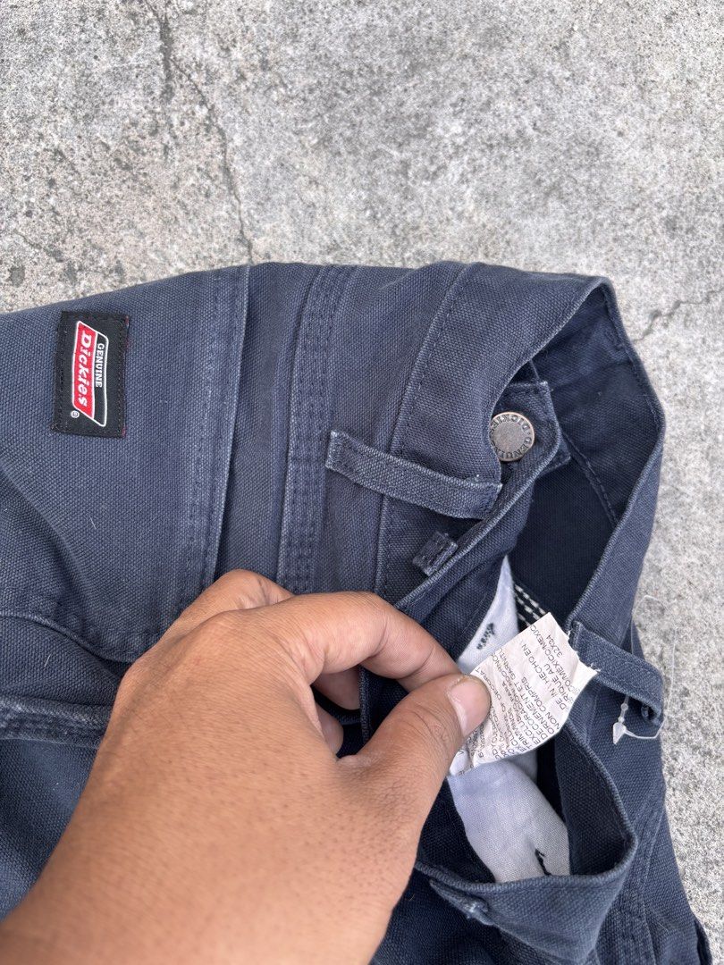 Dickies Black Cargo Pants Workwear Size 32x34 (Category: Trousers) located in Polomolok. Submitted by rrthrift (Listing ID 1470503722, Image 3). Description: - Brand: Genuine Dickies - Color: Dark Navy / Black - Size: 32x34 (Regular Straight Fit) - Material: Heavy-duty cotton duck fabric - Features: Classic utility pockets, hammer loop, button closure, and zip fly - Condition: Sturdy and durable construction.