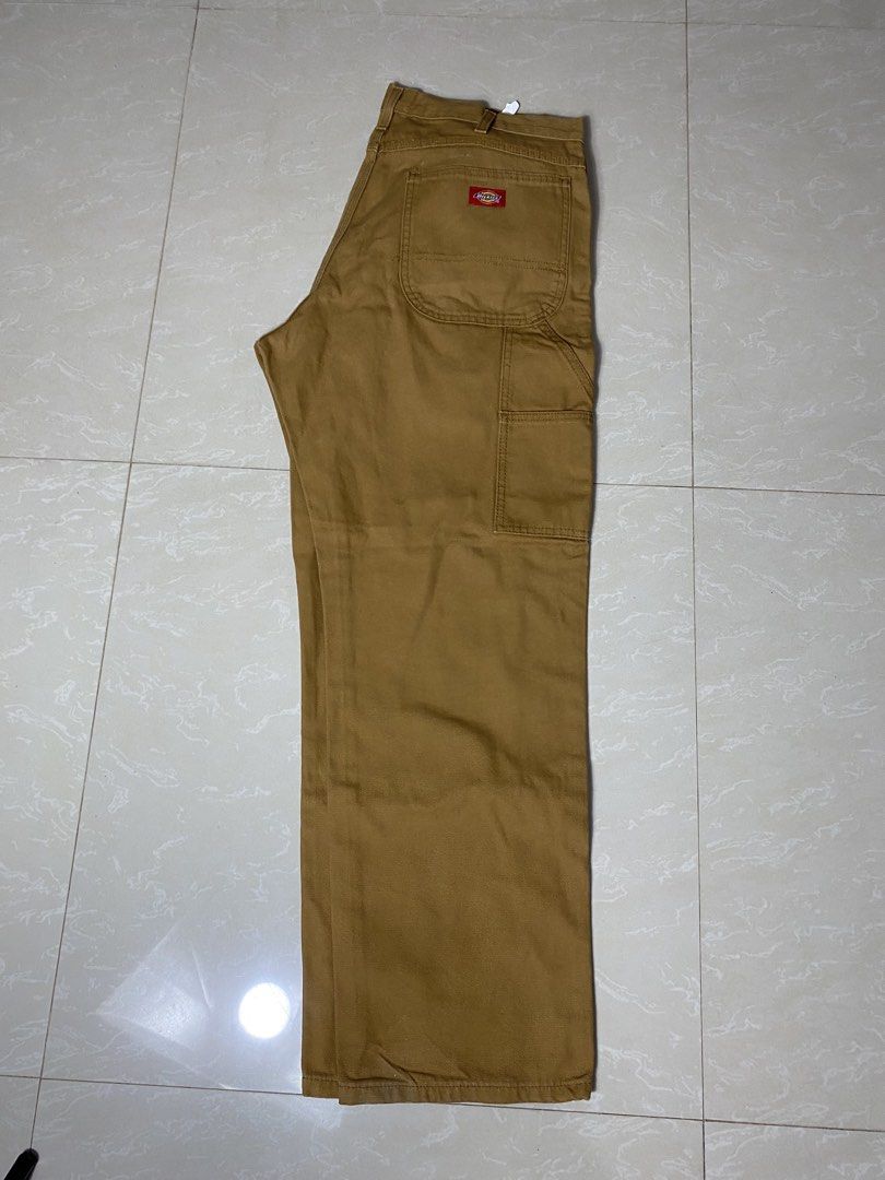 Dickies Brown Duck Canvas Carpenter Pants (Category: Chinos) located in Muntinlupa City. Submitted by ajdomingo504210 (Listing ID 1470384994, Image 1). Description: NO ISSUE AS NEW CONDITION DIMENSIONS: 34 x 42 x 9 - Authentic Dickies carpenter pants in brown duck canvas - Classic heavy-duty workwear style built to last - Functional utility pockets and side hammer loop - Iconic red and yellow logo patch on the back pocket - Secure metal button cl
