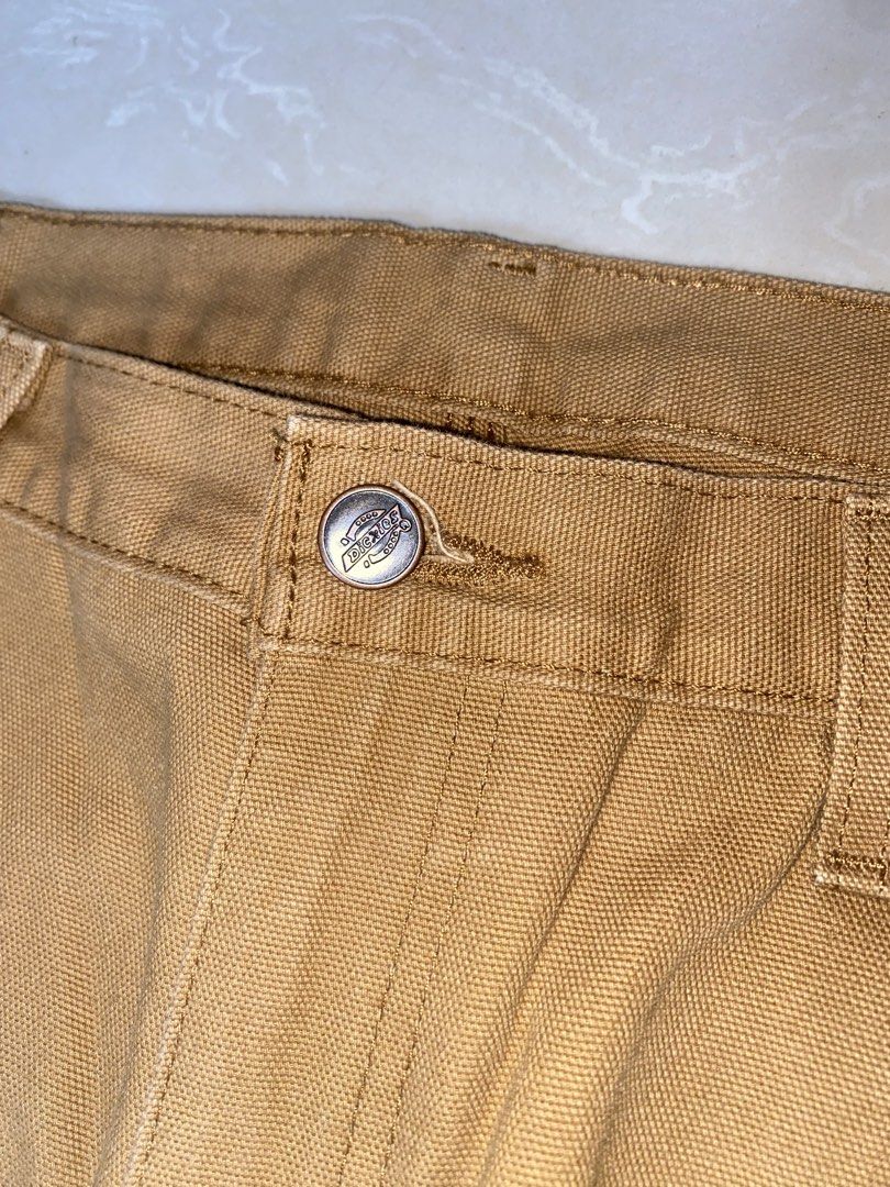 Dickies Brown Duck Canvas Carpenter Pants (Category: Chinos) located in Muntinlupa City. Submitted by ajdomingo504210 (Listing ID 1470384994, Image 3). Description: NO ISSUE AS NEW CONDITION DIMENSIONS: 34 x 42 x 9 - Authentic Dickies carpenter pants in brown duck canvas - Classic heavy-duty workwear style built to last - Functional utility pockets and side hammer loop - Iconic red and yellow logo patch on the back pocket - Secure metal button cl
