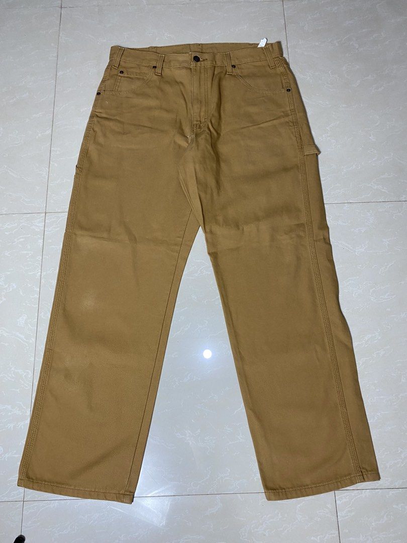 Dickies Brown Duck Canvas Carpenter Pants (Category: Chinos) located in Muntinlupa City. Submitted by ajdomingo504210 (Listing ID 1470384994, Image 2). Description: NO ISSUE AS NEW CONDITION DIMENSIONS: 34 x 42 x 9 - Authentic Dickies carpenter pants in brown duck canvas - Classic heavy-duty workwear style built to last - Functional utility pockets and side hammer loop - Iconic red and yellow logo patch on the back pocket - Secure metal button cl