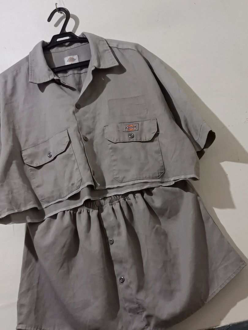 Dickies Grey Short Sleeve Work Shirt Size L (Category: Sets or Coordinates) located in Manila. Submitted by zy0420 (Listing ID 1470430839, Image 2). Description: - Brand: Dickies - Color: Grey - Size: L (Tag on collar) - Dimes: top 26x18 skirt 30-40x14 - Material: 65% polyester, 35% cotton blend - Features: Short sleeves, front button closure, dual chest pockets with button flaps, Dickies logo patch - Origin: Made in Honduras - Condition: Excelle