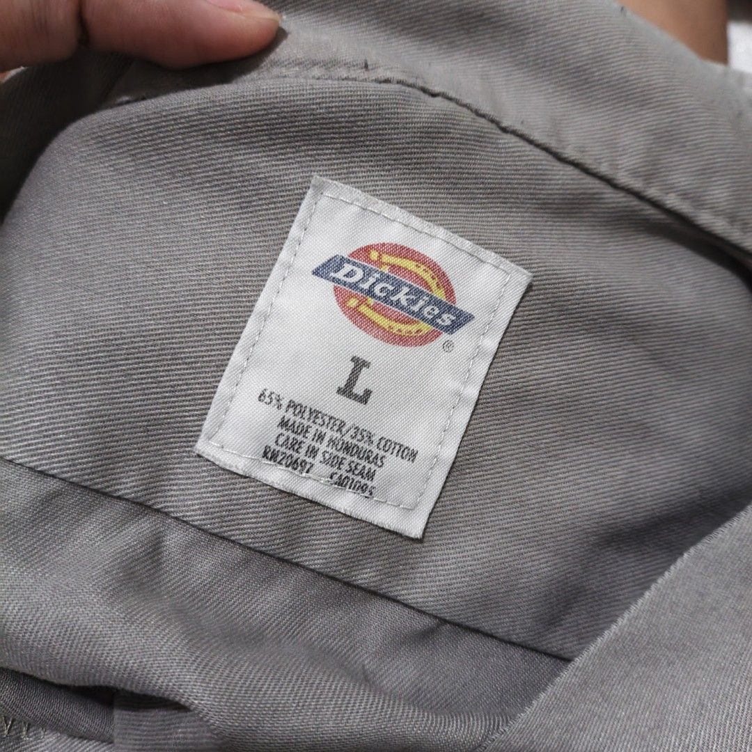 Dickies Grey Short Sleeve Work Shirt Size L (Category: Sets or Coordinates) located in Manila. Submitted by zy0420 (Listing ID 1470430839, Image 3). Description: - Brand: Dickies - Color: Grey - Size: L (Tag on collar) - Dimes: top 26x18 skirt 30-40x14 - Material: 65% polyester, 35% cotton blend - Features: Short sleeves, front button closure, dual chest pockets with button flaps, Dickies logo patch - Origin: Made in Honduras - Condition: Excelle