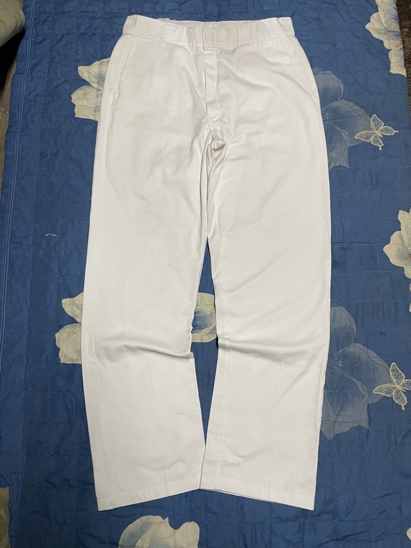 Dickies White Casual Pants (Category: Trousers) located in Manila. Submitted by chawmichael (Listing ID 1470473775, Image 1). Description: - Brand: Dickies - Color: Classic solid white - Fit: Straight leg cut with crisp front creases - Details: Sturdy workwear fabric, standard belt loops - Pockets: Back welt pockets (left with button closure, right with signature Dickies logo tag) - Style: Minimalist streetwear staple Good as new Dimes W 36 L 46 