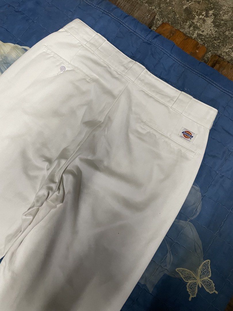 Dickies White Casual Pants (Category: Trousers) located in Manila. Submitted by chawmichael (Listing ID 1470473775, Image 3). Description: - Brand: Dickies - Color: Classic solid white - Fit: Straight leg cut with crisp front creases - Details: Sturdy workwear fabric, standard belt loops - Pockets: Back welt pockets (left with button closure, right with signature Dickies logo tag) - Style: Minimalist streetwear staple Good as new Dimes W 36 L 46 