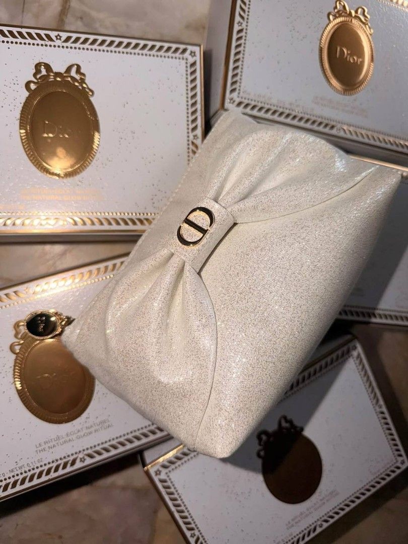 Dior Holiday 2026 Gift Collection (Category: Luxury Bags & Wallets) located in Manila. Submitted by rani143 (Listing ID 1470469630, Image 2). Description: - Authentic Dior cosmetic pouch in a gorgeous white sparkly finish - Features a chic large front bow accented with iconic CD gold logo hardware - Secure zipper closure complete with a branded gold zipper pull charm - Eye-catching shimmery material that beautifully catches the light - Spacious e