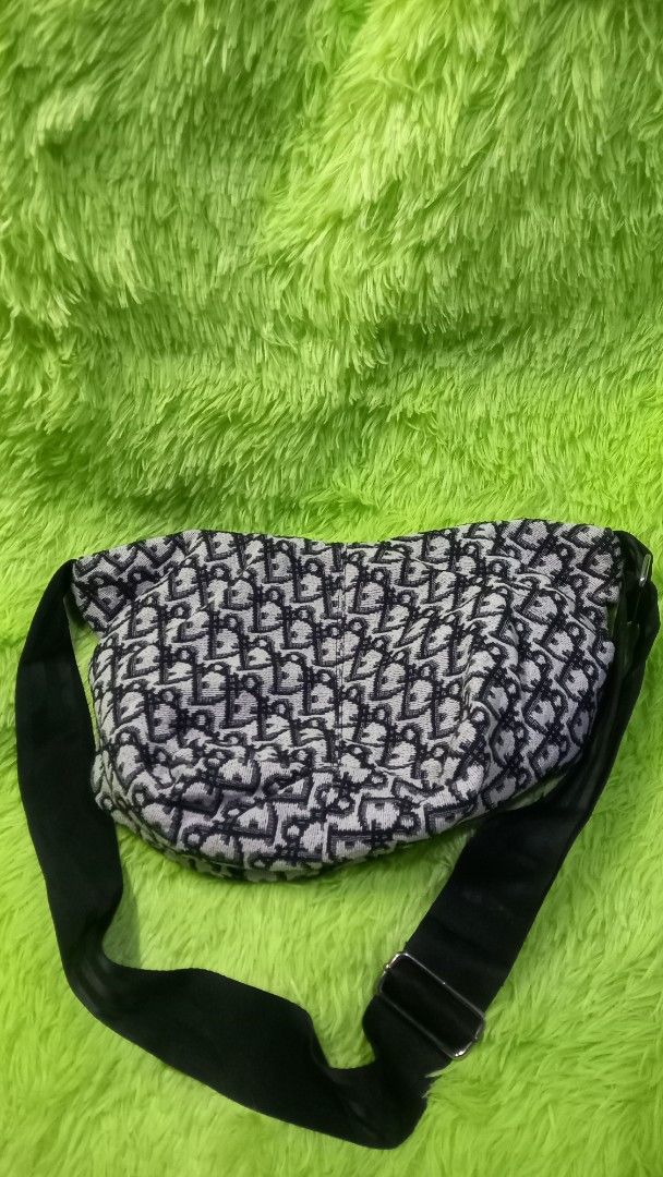Dior Monogram Pattern Crossbody Sling Bag Black White (Category: Luxury Bags & Wallets) located in Manila. Submitted by twinklelyn03 (Listing ID 1470417835, Image 2). Description: - monogram fabric in a timeless black and white colorway - Secure zipper top closure to keep your essentials safe - Adjustable black strap with sleek metal buckle hardware - Spacious dark fabric interior equipped with convenient slip pockets - Compact and stylish design