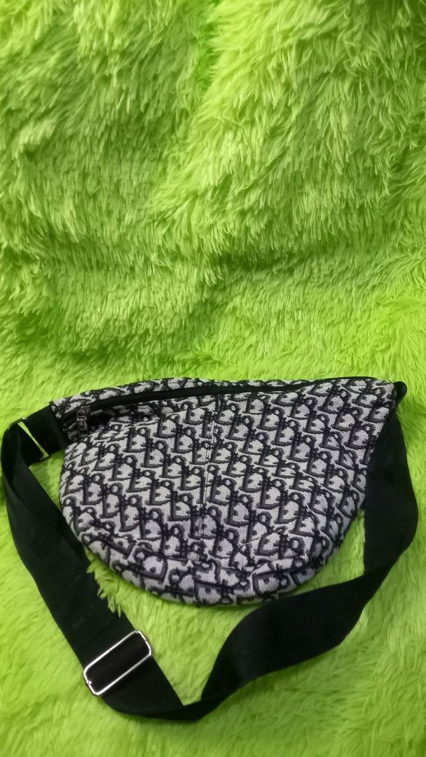 Dior Monogram Pattern Crossbody Sling Bag Black White (Category: Luxury Bags & Wallets) located in Manila. Submitted by twinklelyn03 (Listing ID 1470417835, Image 1). Description: - monogram fabric in a timeless black and white colorway - Secure zipper top closure to keep your essentials safe - Adjustable black strap with sleek metal buckle hardware - Spacious dark fabric interior equipped with convenient slip pockets - Compact and stylish design