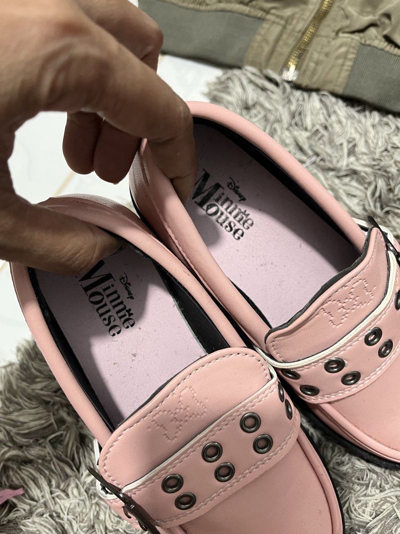 Disney Minnie Mouse Pink Platform Loafers (Category: Loafers) located in Lucena. Submitted by cheapanddealshop (Listing ID 1470550391, Image 2). Description: - Authentic Disney Minnie Mouse design in a stylish pink color - Features a trendy chunky black lug sole and slip-on fit - Adorned with a front buckle strap and metal eyelet details - Embossed Minnie silhouette on the side for a cute touch - Pink cushioned insoles for all-day comfort.