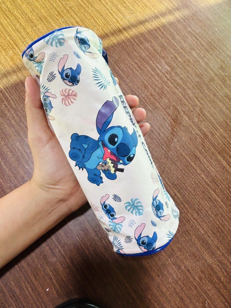 Disney Stitch Tropical Design Pencil Case Keepin It Cool (Category: Stationery & School Supplies) located in Manila. Submitted by starbalesukandjapansurplus (Listing ID 1470555670, Image 1). Description: - Design: Cute Stitch character with tropical leaf print and 'Keepin it cool' text - Color/Closure: Blue zipper closure down the middle - Shape: Roomy cylinder design, perfect for pens and stationery - Condition: Shows minor wear marks inside fro