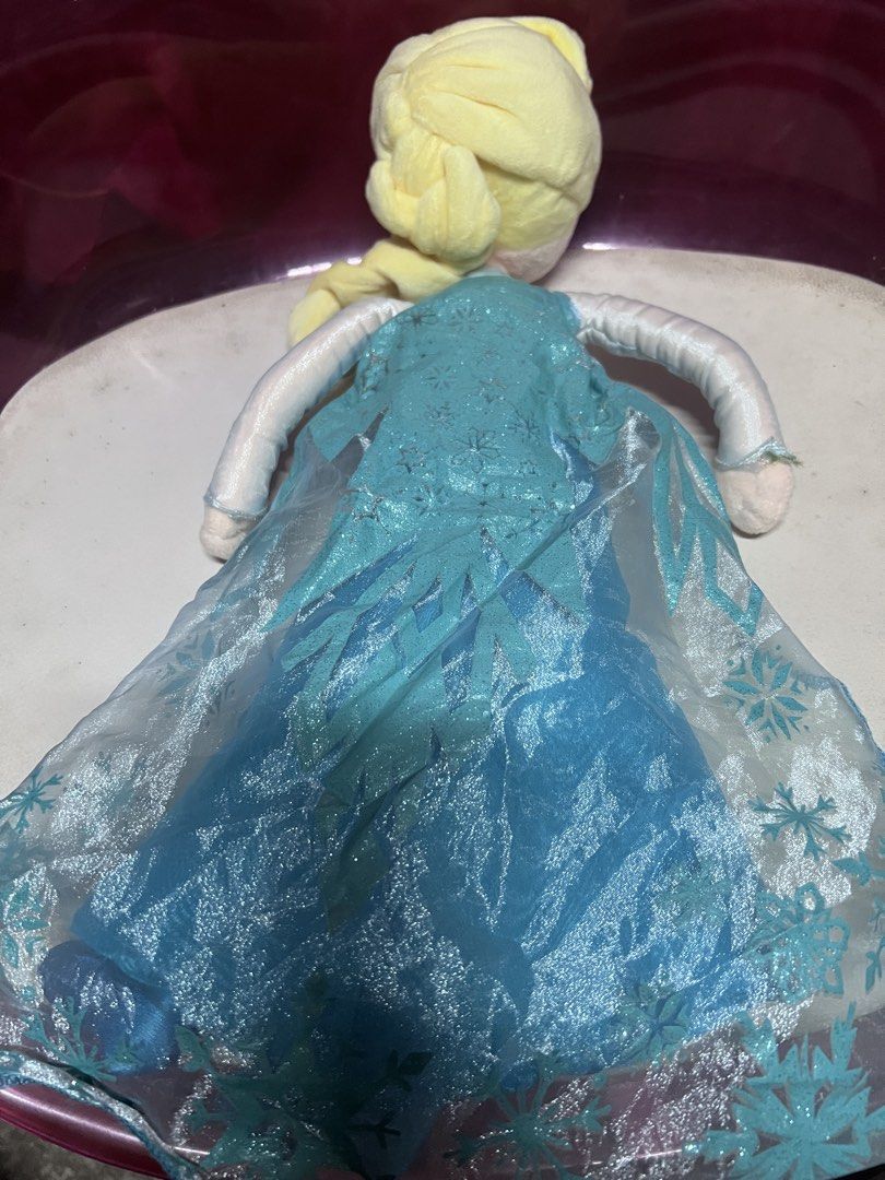 Disney Store Frozen Elsa Plush Doll (Category: Plushies & Soft Toys) located in Bulacan. Submitted by haven_plushie_dolls.888 (Listing ID 1470428781, Image 2). Description: - 100% Authentic Disney Store Elsa plush toy from Frozen - Features her iconic blue dress with sparkly snowflake cape and braided blonde hair - Made with soft, huggable fabric - great for kids or collectors - Official tag attached underneath the dress.