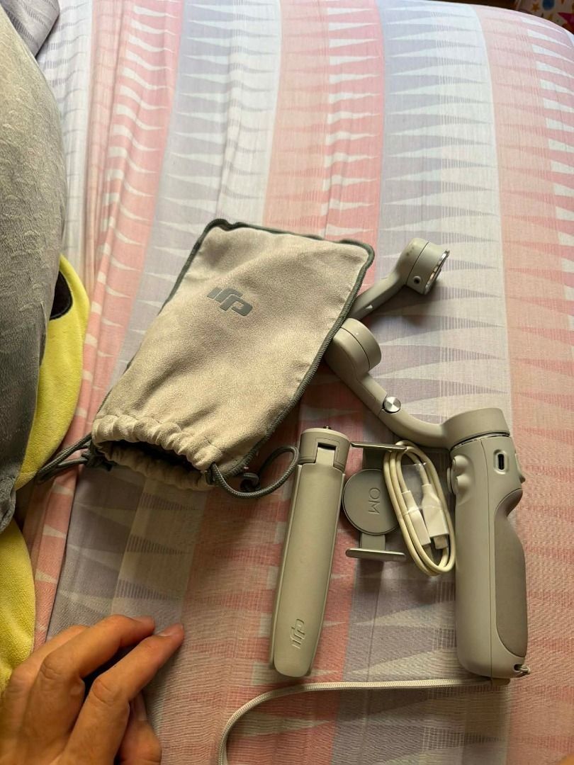 DJI OM 5 Smartphone Gimbal Stabilizer (Category: Gimbals & Stabilizers ) located in Manila. Submitted by johndytaga02095 (Listing ID 1470533762, Image 2). Description: - Model: DJI OM 5 (Sunset White) - Condition: Excellent, complete set - Includes: Magnetic phone clamp, mini tripod stand, power cable, and storage pouch - Features: Portable design, perfect for smooth video shots and phone vlogging - Reason for selling: Decluttering gear.