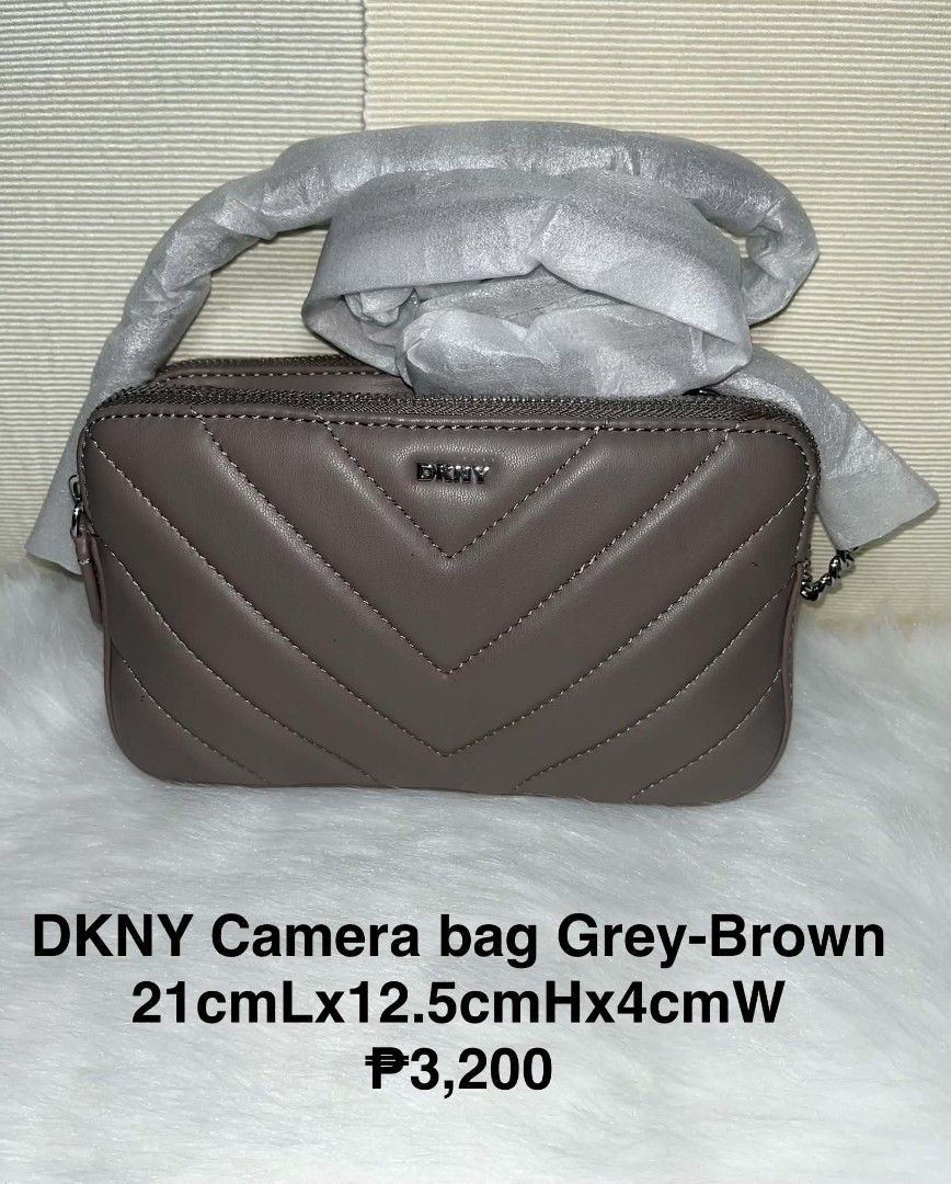 DKNY Camera bag Grey-Brown (Category: Luxury Bags & Wallets) located in Imus. Submitted by maria_pilayo (Listing ID 1470436134, Image 1). Description: - Brand: DKNY - 💯 % Authentic - Style: Quilted chevron camera bag - Color: Grey-brown with silver-tone hardware - Condition: Brand new, strap still wrapped in protective foam - Closure: Top zipper closure - Dimensions: 21cm (L) x 12.5cm (H) x 4cm (W) - Perfect compact size for daily wear.