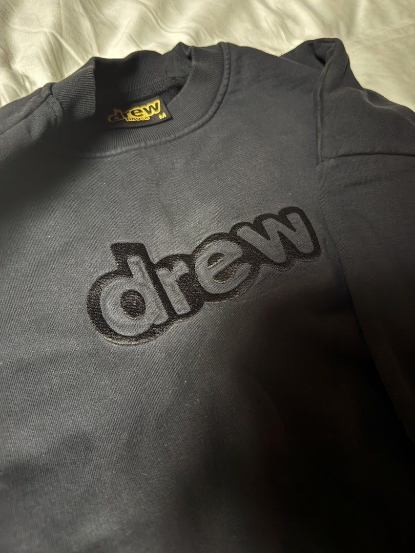 drew house black embroidered sweatshirt medium (Category: Coats, Jackets and Outerwear) located in Manila. Submitted by seangoart (Listing ID 1470350312, Image 3). Description: - Brand: Drew House - Item: Crewneck Sweatshirt - Color: Black with dark grey & black embroidered chest logo - Size: Medium (Classic streetwear fit) - Material: Heavyweight cotton with ribbed cuffs and hem - Condition: Authentic with original neck tag included.