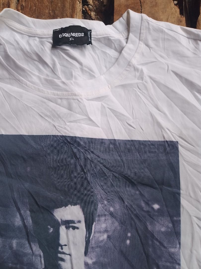 DSquared2 Bruce Lee Graphic T-Shirt (Category: Tshirts & Polo Shirts ) located in Caloocan City. Submitted by alfepangasate1021 (Listing ID 1470402700, Image 2). Description: - Brand: Dsquared2 (Distributed by Staff International) - Color: White - Design: Large front graphic print of Bruce Lee with nunchucks - Style: Classic crew neck, short sleeves - Origin: Made in Italy - Condition: Clean, well-maintained piece with crisp graphics.