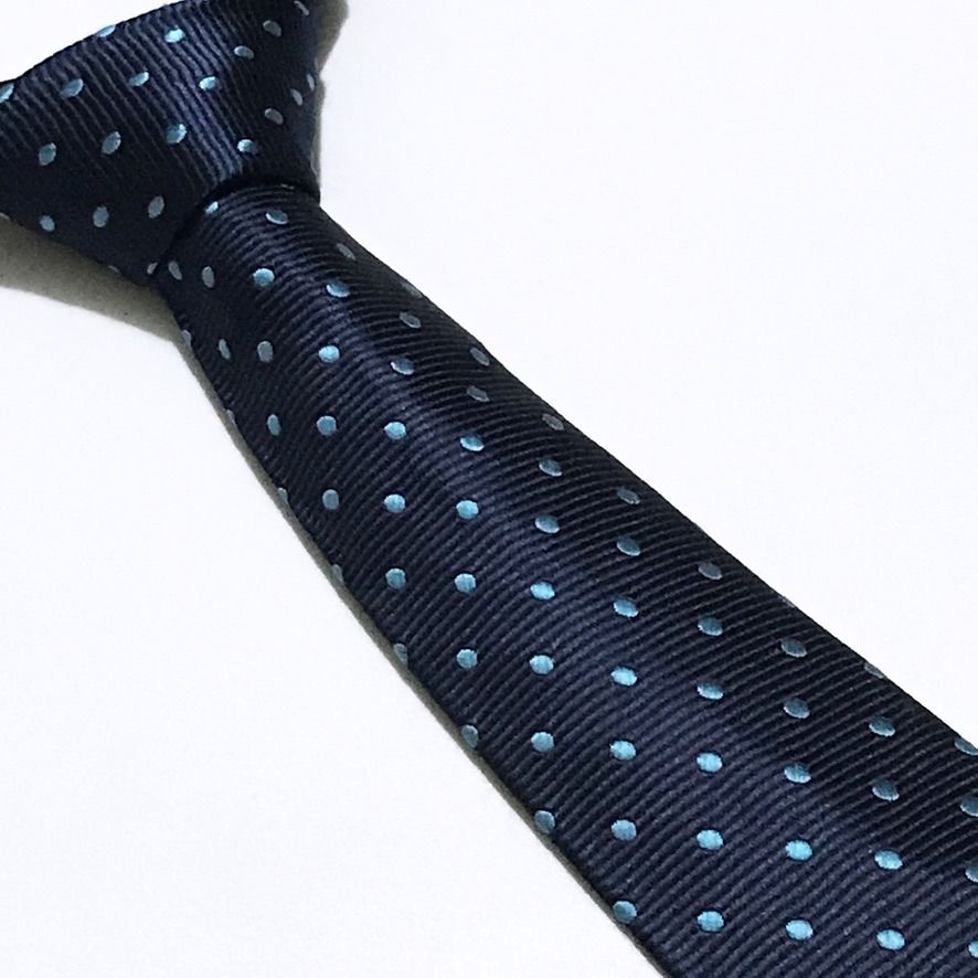 DWAN Hand Made Ribbed Textured Polka Dot Neck Tie (Category: Ties) located in Taguig. Submitted by retrogaze (Listing ID 1470487514, Image 1). Description: This handmade slim necktie by DWAN features a deep navy blue base woven with a pronounced horizontal ribbed repp texture. The body is styled in a modern slim silhouette and decorated with an orderly, repeating polka dot pattern woven in vibrant turquoise-cyan blue silk. Recommended Suit & Shir