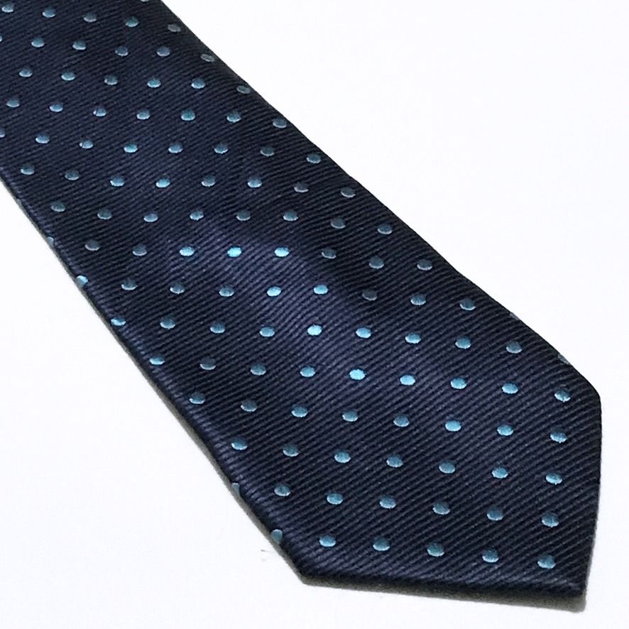 DWAN Hand Made Ribbed Textured Polka Dot Neck Tie (Category: Ties) located in Taguig. Submitted by retrogaze (Listing ID 1470487514, Image 2). Description: This handmade slim necktie by DWAN features a deep navy blue base woven with a pronounced horizontal ribbed repp texture. The body is styled in a modern slim silhouette and decorated with an orderly, repeating polka dot pattern woven in vibrant turquoise-cyan blue silk. Recommended Suit & Shir