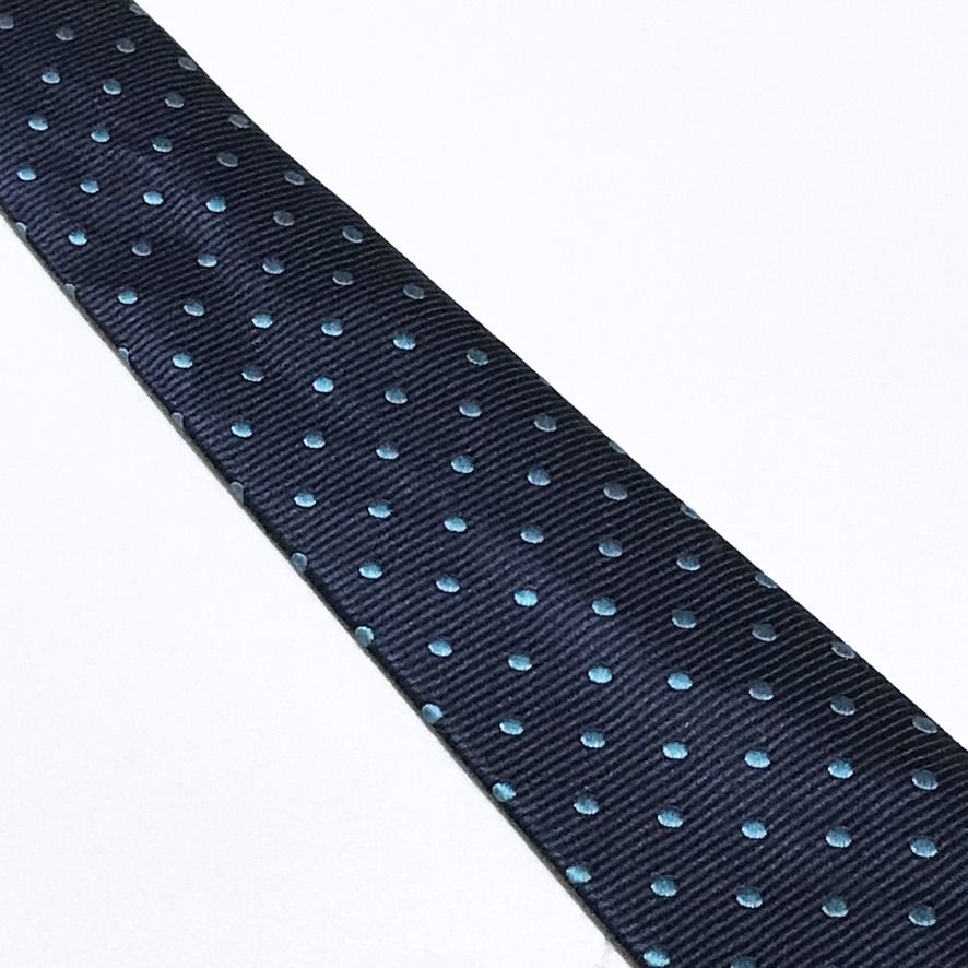 DWAN Hand Made Ribbed Textured Polka Dot Neck Tie (Category: Ties) located in Taguig. Submitted by retrogaze (Listing ID 1470487514, Image 3). Description: This handmade slim necktie by DWAN features a deep navy blue base woven with a pronounced horizontal ribbed repp texture. The body is styled in a modern slim silhouette and decorated with an orderly, repeating polka dot pattern woven in vibrant turquoise-cyan blue silk. Recommended Suit & Shir