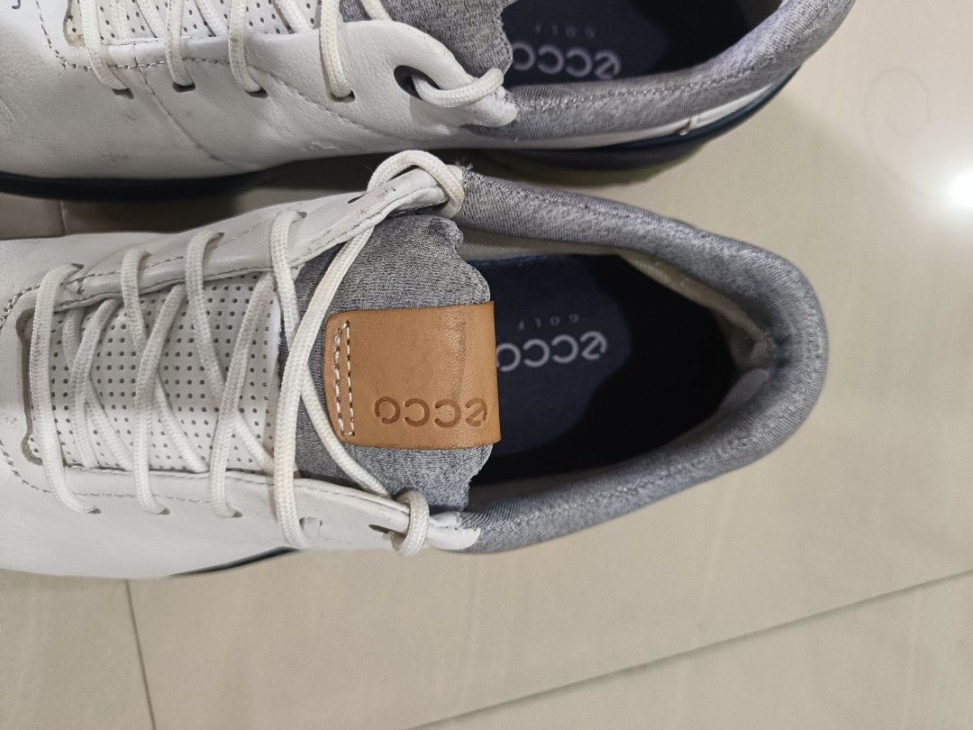 ECCO Biom Golf Shoes White Navy US 8 (Category: Golf) located in Davao. Submitted by judethrifter (Listing ID 1470468924, Image 3). Description: - Brand: ECCO Biom Golf Shoes - Colorway: White, navy, and grey with green spiked outsoles - Weatherproofing: 100% waterproof Gore-Tex technology - Material: Premium leather upper with breathable perforated details and a cozy knit collar - Traction: Spiked green outsoles designed for maximum grip on the 
