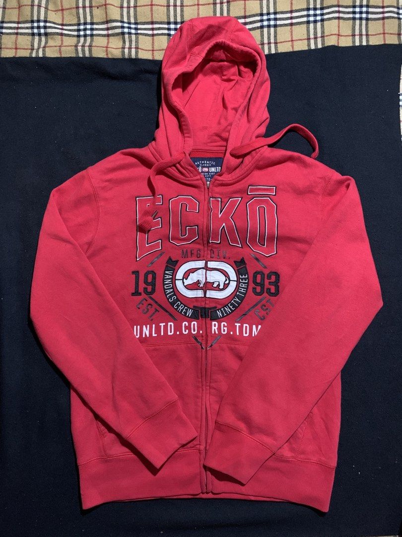 Ecko Unltd Red Zip-Up Hoodie (Category: Coats, Jackets and Outerwear) located in Cagayan de Oro. Submitted by chabermz (Listing ID 1470533464, Image 1). Description: - Brand: Ecko Unltd. - Color: Bright Red - Size: Small - Design: Large chest graphic with rhino logo and '1993' - Material: Cotton-polyester blend with soft fleece lining - Features: Attached hood with drawstrings, front pockets, ribbed cuffs, and hem - Issue cant lock the zipper Dim